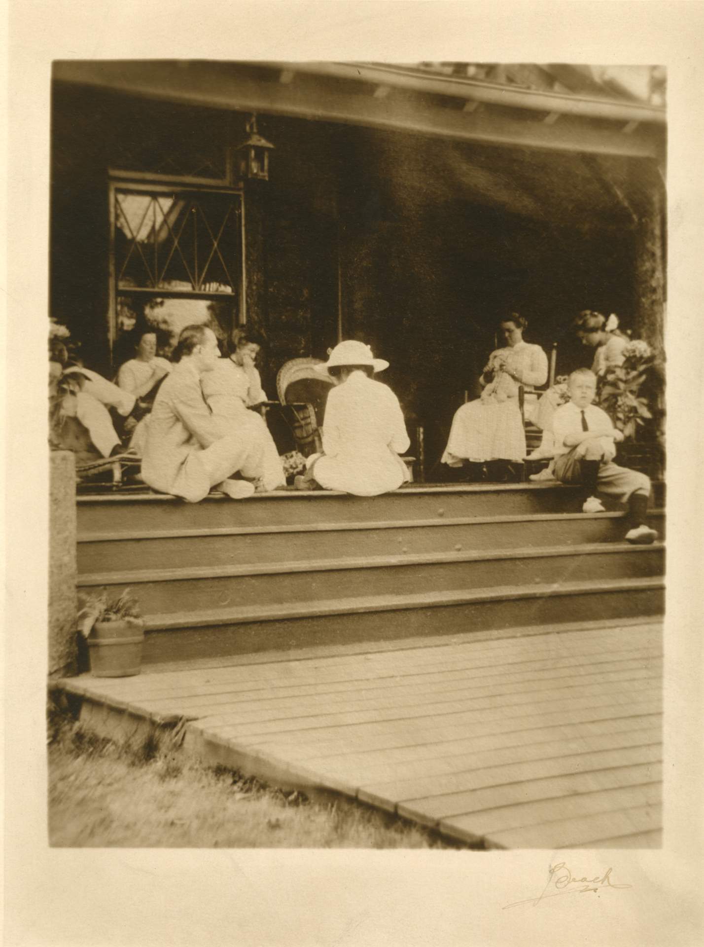 Untitled [group seated on a porch]