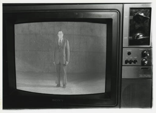[Gerald O'Grady on a television screen]