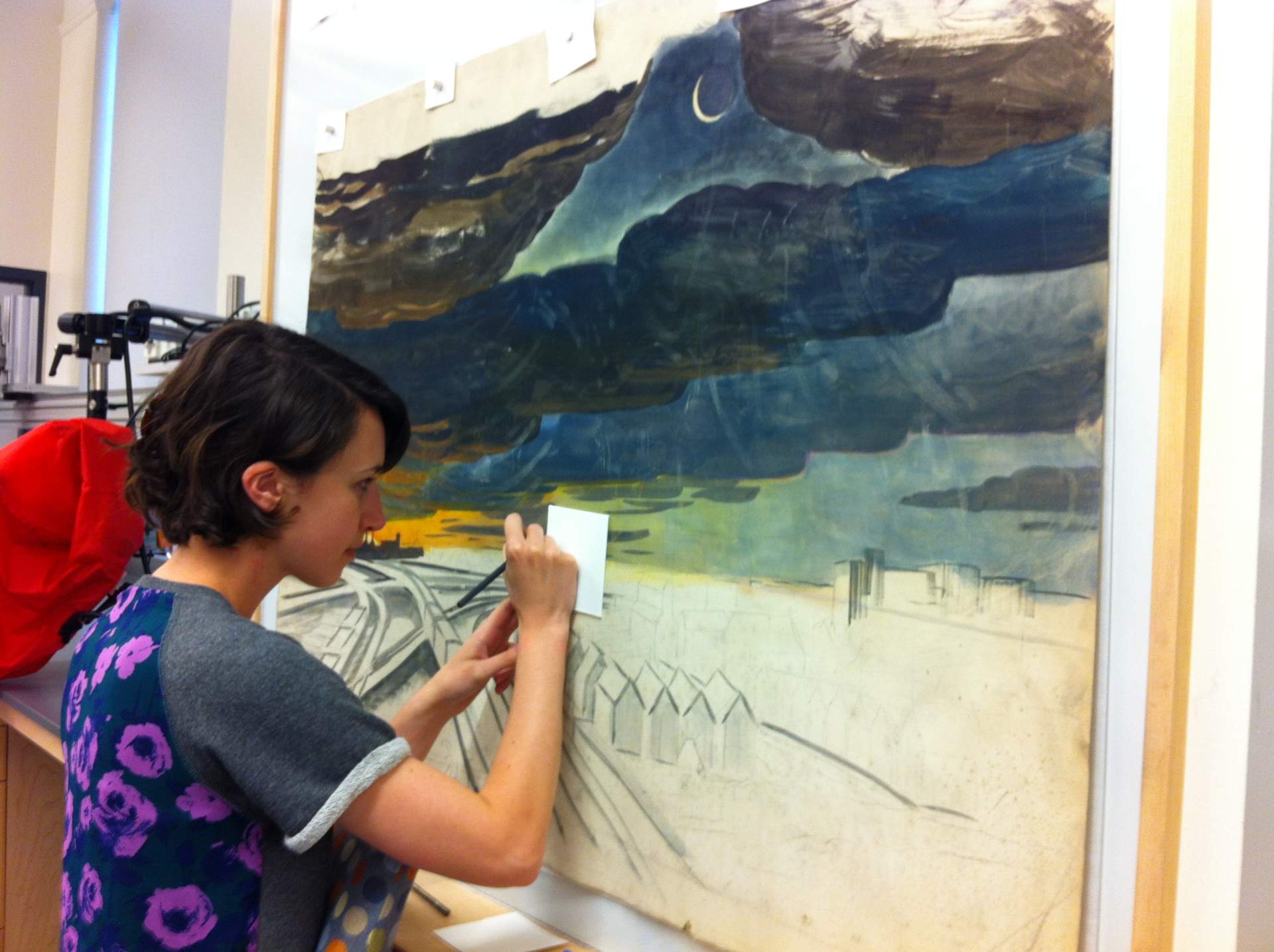 Christina Taylor working on New Moon #10 by Charles E. Burchfield in the Art Conservation Department
