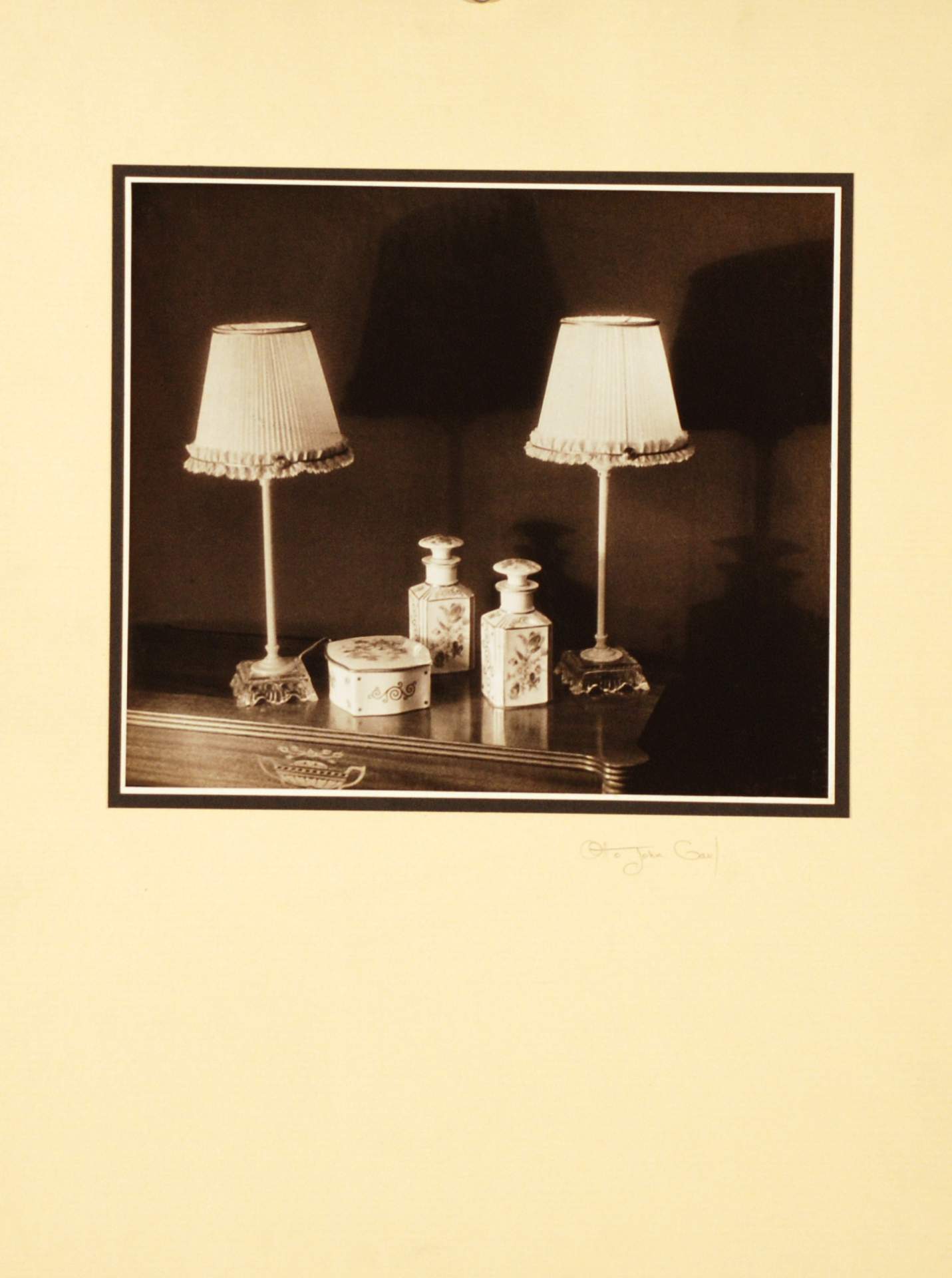 Untitled [lamps and lidded bottles and box on a dresser]