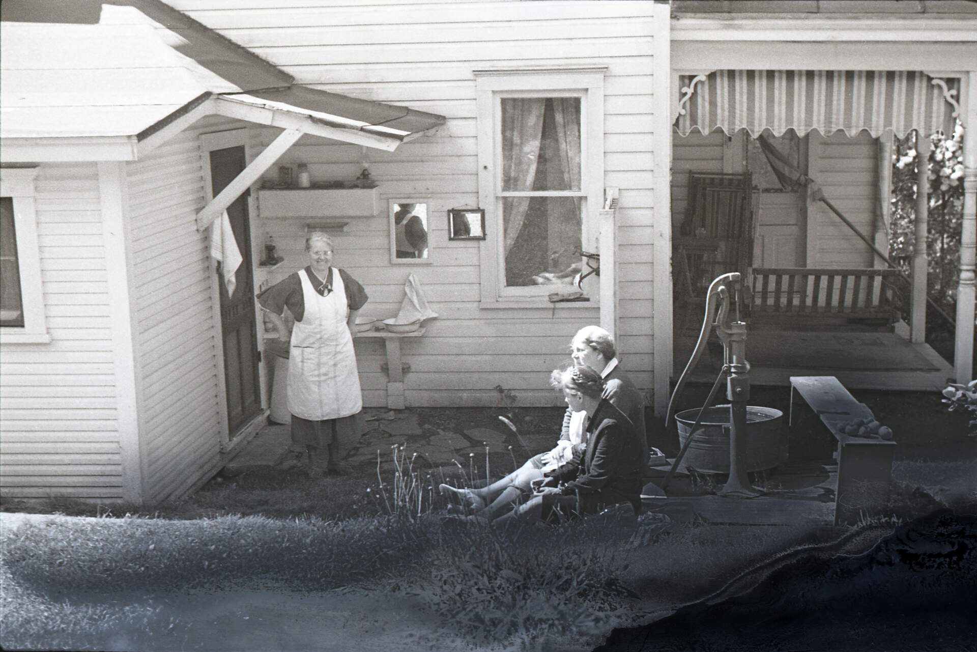 Untitled photographic negative (Virginia with two women outside of house)