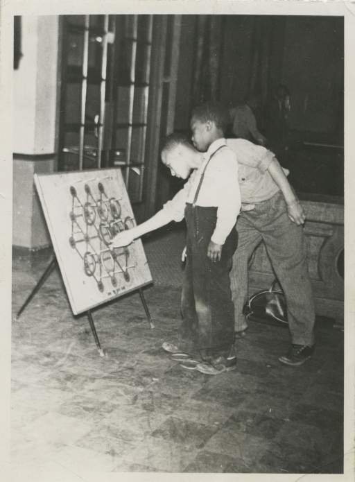 Boy’s Dept. (Boys playing ring toss game)