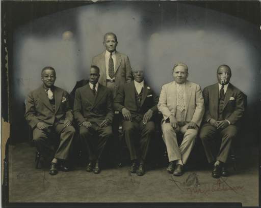 John E. Brent standing among the Board of Managers